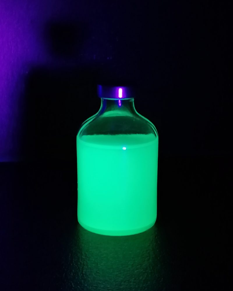 Green fluorescent material in a vial